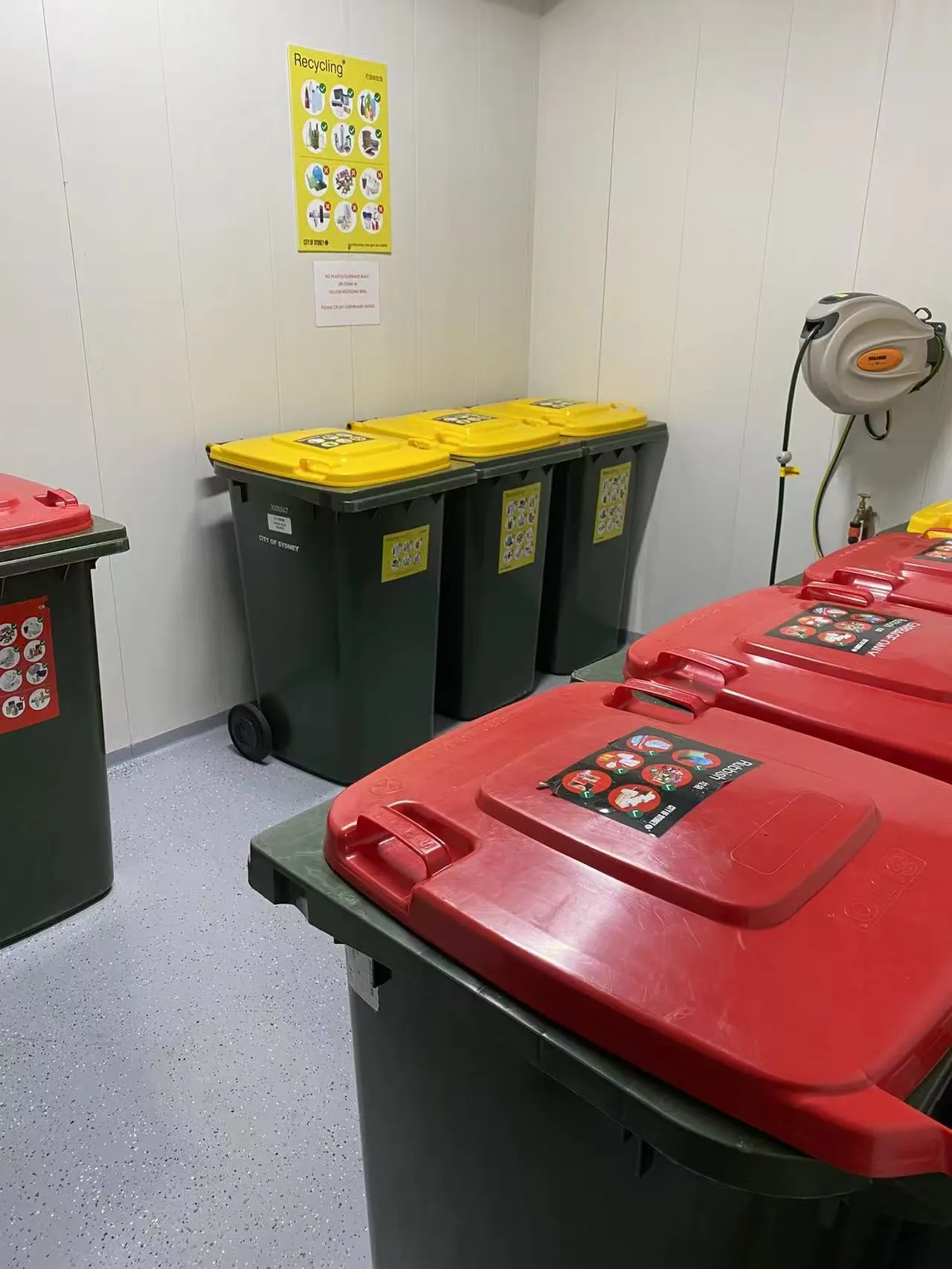 Clean and organised strata bin room with general-waste and recycling bins
