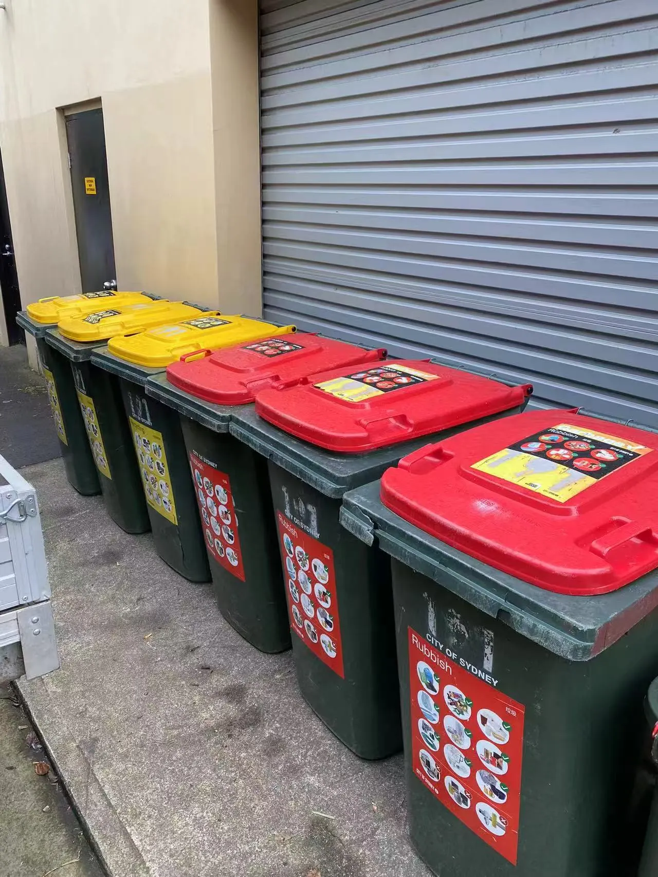 Strata waste and recycling bins arranged neatly for scheduled collection service